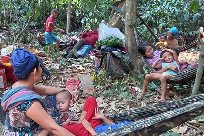 In this photo released by the Free Burma Rangers, Karen villagers gather in the forests as they hide from military airstrikes in the Deh Bu Noh area of the Papun district, north Karen state, Myanmar, Sunday, March 28, 2021. Thai authorities along its northwestern border braced themselves, Monday, for a possible influx of more ethnic Karen villagers fleeing the fear of renewed air strikes from the Myanmar military. (Free Burma Rangers via AP)