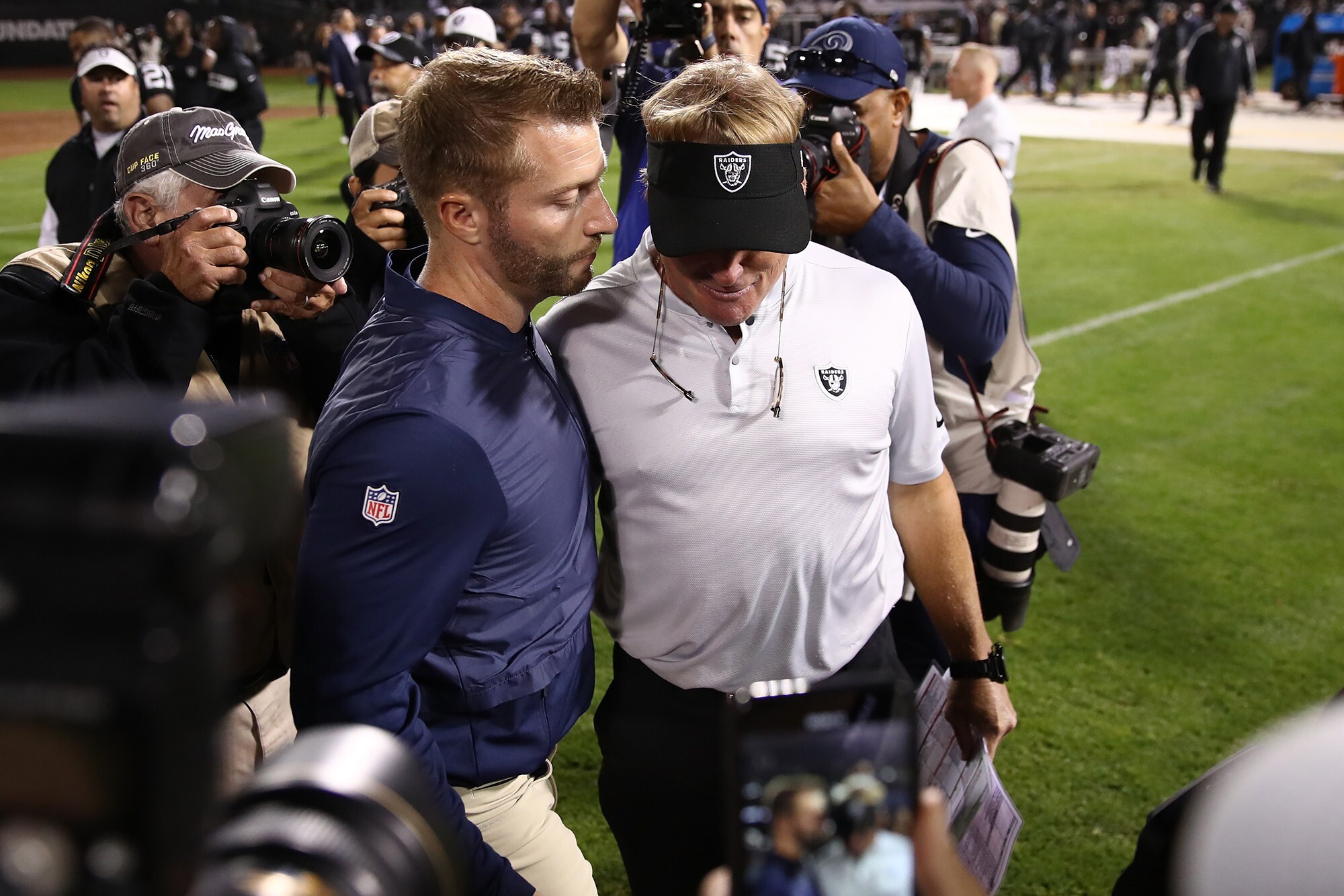 Rams coach Sean McVay and Raiders coach Jon Gruden share a moment on the sideline.