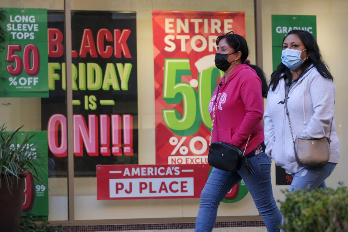 FILE - Black Friday shoppers wearing face masks shop at the Citadel Outlets in Commerce, Calif., Nov. 26, 2021. Black Friday sales are everywhere. But what actually makes a Black Friday deal worth pursuing? An item’s reduced price, availability and affordability are key elements. (AP Photo/Ringo H.W. Chiu, File)