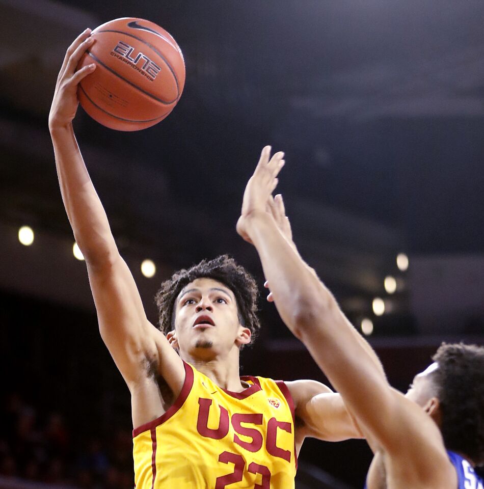 USC forward Max Agbonkpolo shoots over Florida Gulf Coast forward Qwanzi Samuels during the first half.