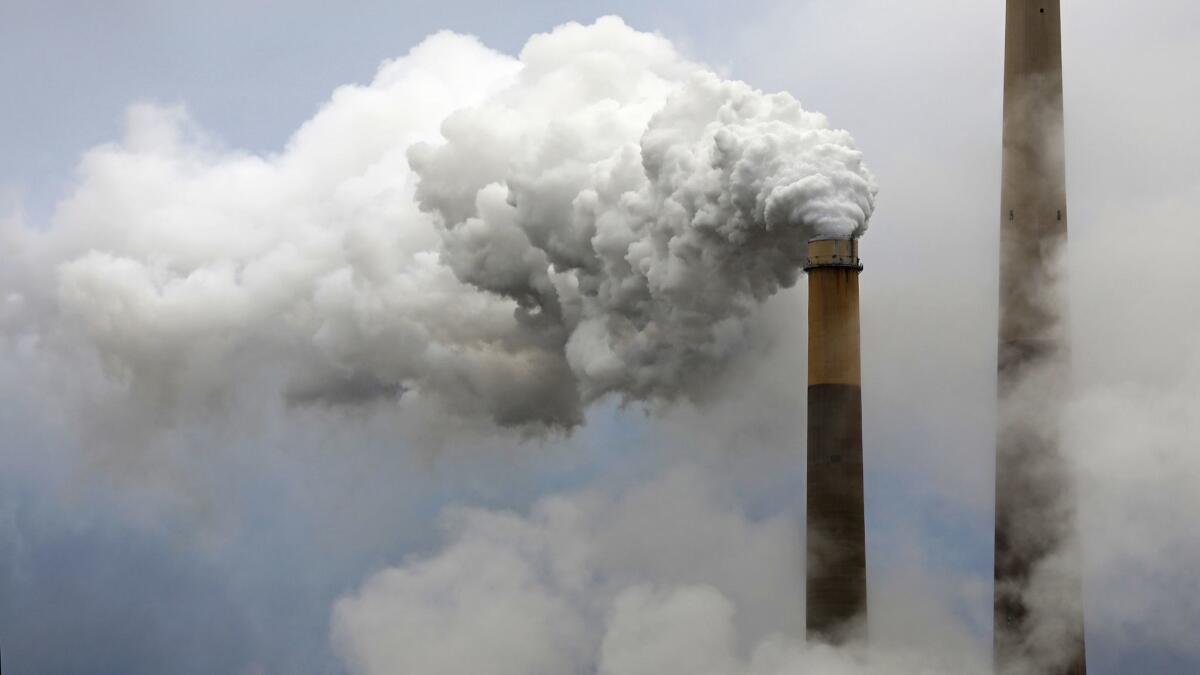 Steam rises from a stack at a coal-burning power station.