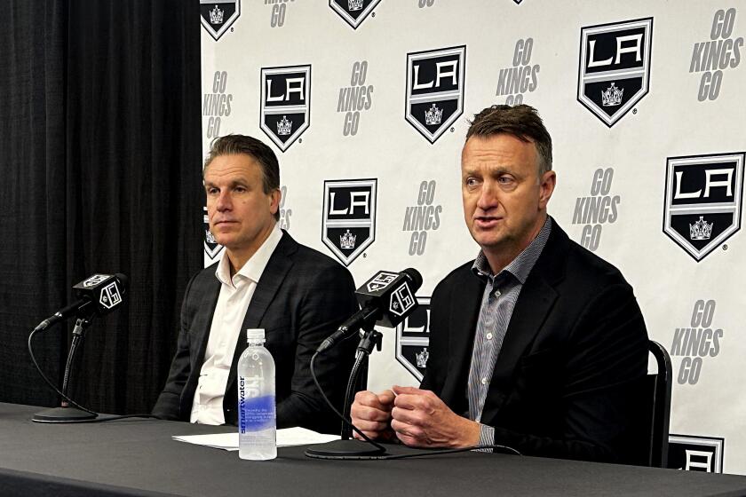 Kings general manager Rob Blake (right) introduces new head coach Jim Hiller, who was the interim coach.