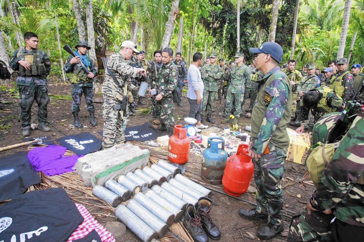 Philippine soldiers in Mindanao display improvised explosive devices seized last month.