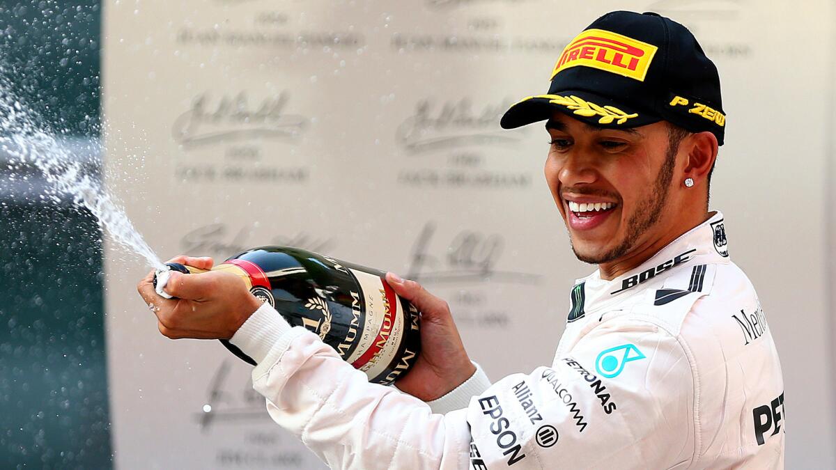Mercedes driver Lewis Hamilton celebrates after winning the Formula One Grand Prix of China on Sunday.