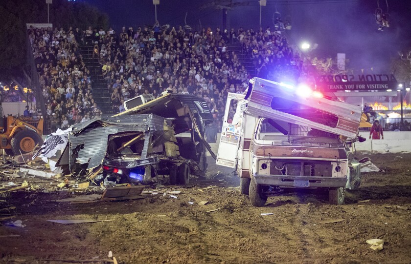 Tony Axton, left, and Scott Loughner battle it out during the Motorhome Madness demolition derby.