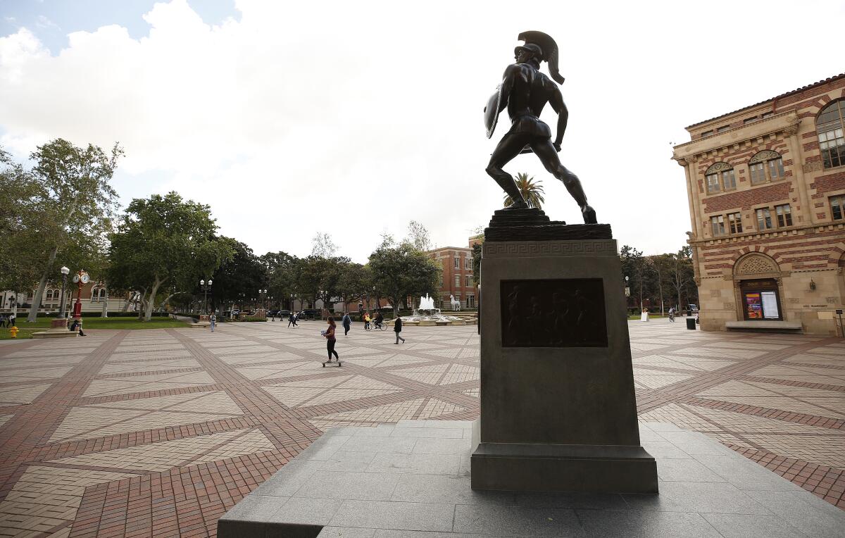 Tommy Trojan statue stands in a USC campus plaza 