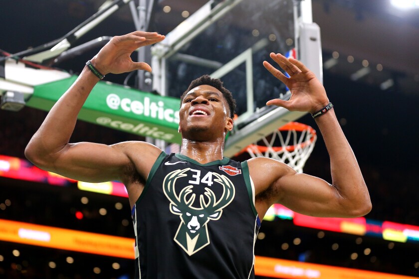 Bucks forward Giannis Antetokounmpo flexes after dunking against the Wizards during a preseason game on Oct. 13, 2019.