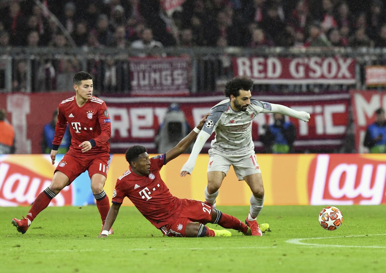 Liverpool forward Mohamed Salah, right, duels for the ball with Bayern defender David Alaba during the Champions League round of 16 second leg soccer match between Bayern Munich and Liverpool at the Allianz Arena, in Munich, Germany, Wednesday, March 13, 2019. (AP Photo/Kerstin Joensson)