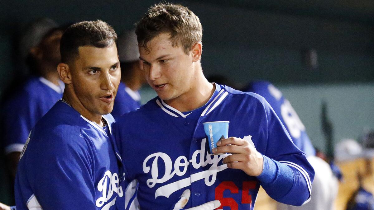 Dodgers shortstop Alex Guerrero, left, is congratulated by teammate Joc Pederson after hitting a grand slam during an exhibition game against the Cincinnati Reds in March. Pederson, who is playing with Triple-A Albuquerque, has a separated shoulder.