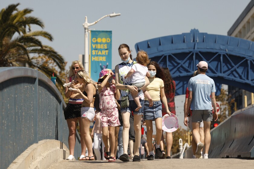 California is dramatically reopening amid warnings of a
spring COVID-19 wave. How big is the risk? 2 SANTA MONIA, CA - MARCH 29: A number of people visiting the Santa Monica Pier ebs and flows as people take advantage of the warm weather during the COVID-19 Spring break in Southern California Monday. Santa Monica Pier and Promenade on Monday, March 29, 2021 in Santa Monia, CA. (Al Seib / Los Angeles Times).
