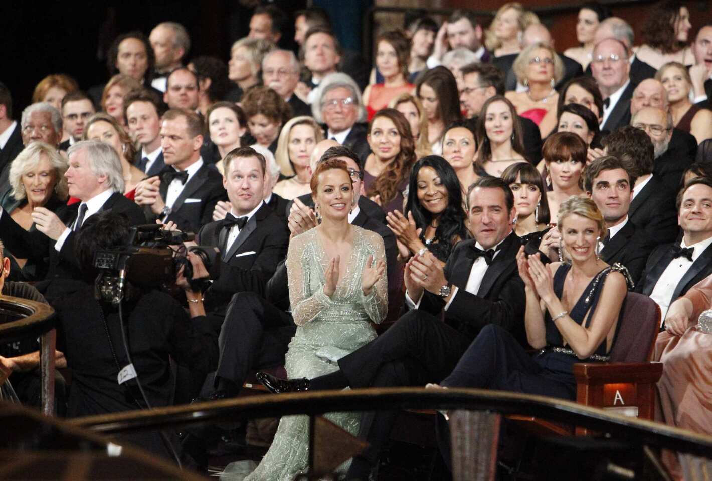 Berenice Bejo and Jean Dujardin are spotted in their seats at the 2012 Academy Awards in Hollywood.