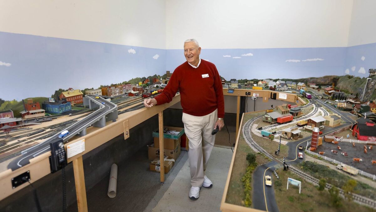 Ron Ludwig, 82, demonstrates just one the HO scale electric model railroad train layouts he has built at the La Costa Glen retirement community in Carlsbad.