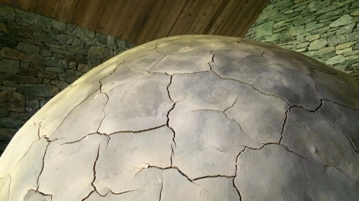 The first of the Clay Houses contains the piece "Boulder," a giant sphere crafted entirely out of unfired clay. It will decompose over time.
