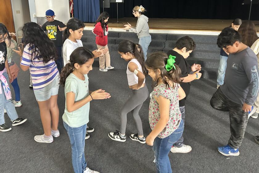 Paradise Hills Elementary students learn Ballet Folklorico dancing with instructor Angela Santana, center background.