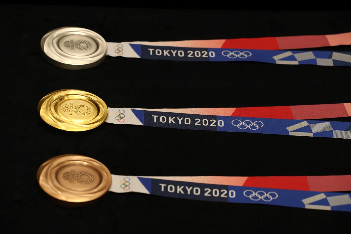 Medals for the Tokyo 2020 Olympic Games are displayed.