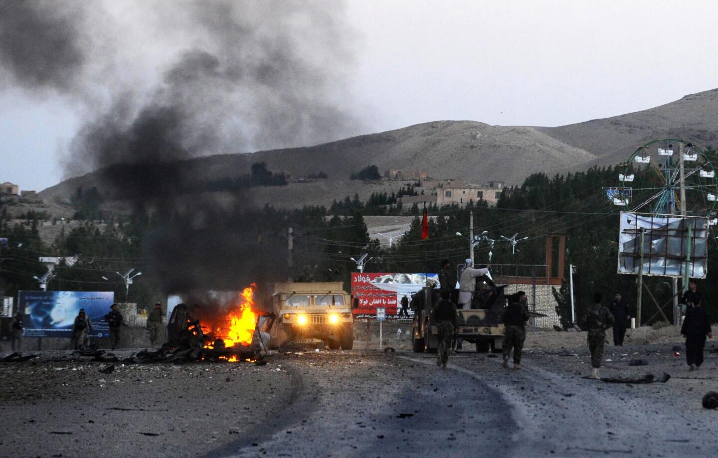 Smoke rises from a burning vehicle near the U.S. Consulate after an attack by a car bomb followed by a gunfight in Herat, Afghanistan. Seven heavily armed Taliban suicide attackers struck the consulate before dawn, setting off two car bombs and sparking a shootout with U.S. forces.