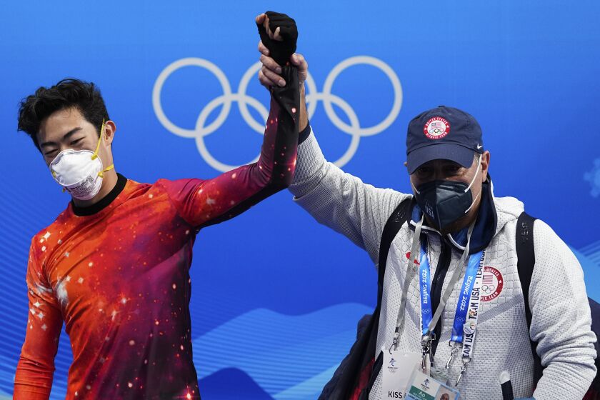 Nathan Chen, left, of the United States, celebrates with his coach Rafael Arutyunyan after winning the gold medal in the men's free skate program during the figure skating event at the 2022 Winter Olympics, Thursday, Feb. 10, 2022, in Beijing. (AP Photo/David J. Phillip)