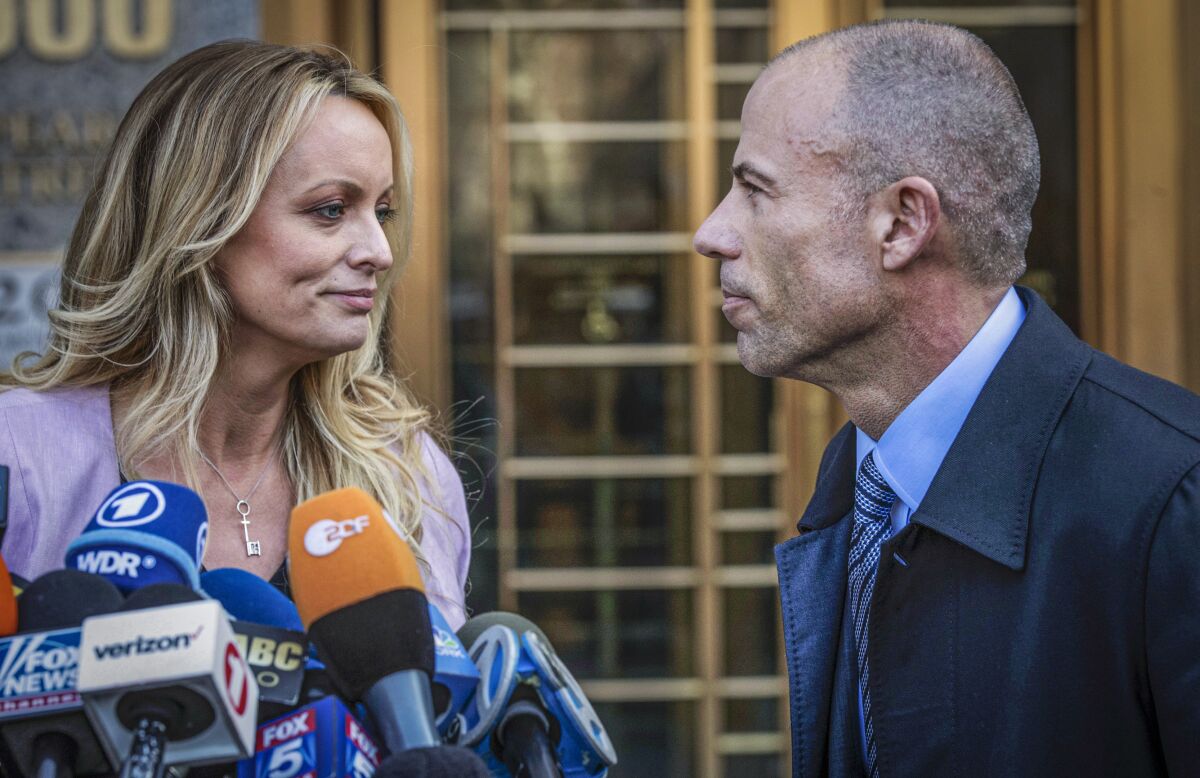 Adult film actress Stormy Daniels stands with her lawyer Michael Avenatti outside federal court in New York, April 16, 2018. 