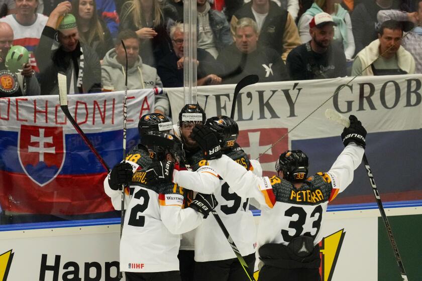 Germany's Dominik Kahun celebrates with teammates after scoring his side's third goal during the preliminary round match between Slovakia and Germany at the Ice Hockey World Championships in Ostrava, Czech Republic, Friday, May 10, 2024. (AP Photo/Darko Vojinovic)