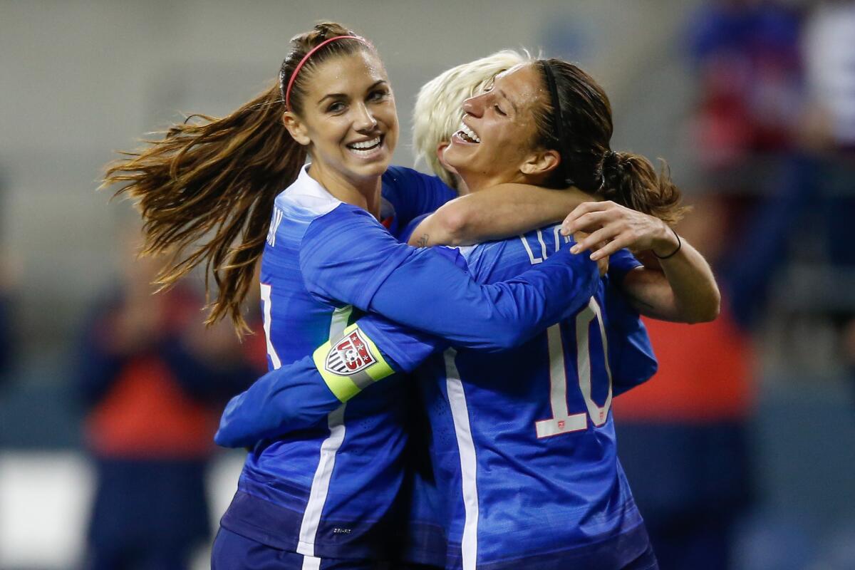 Carli Lloyd, right, celebrates with Alex Morgan after scoring a goal for the U.S. against Brazil during a match in Seattle on Oct. 21.