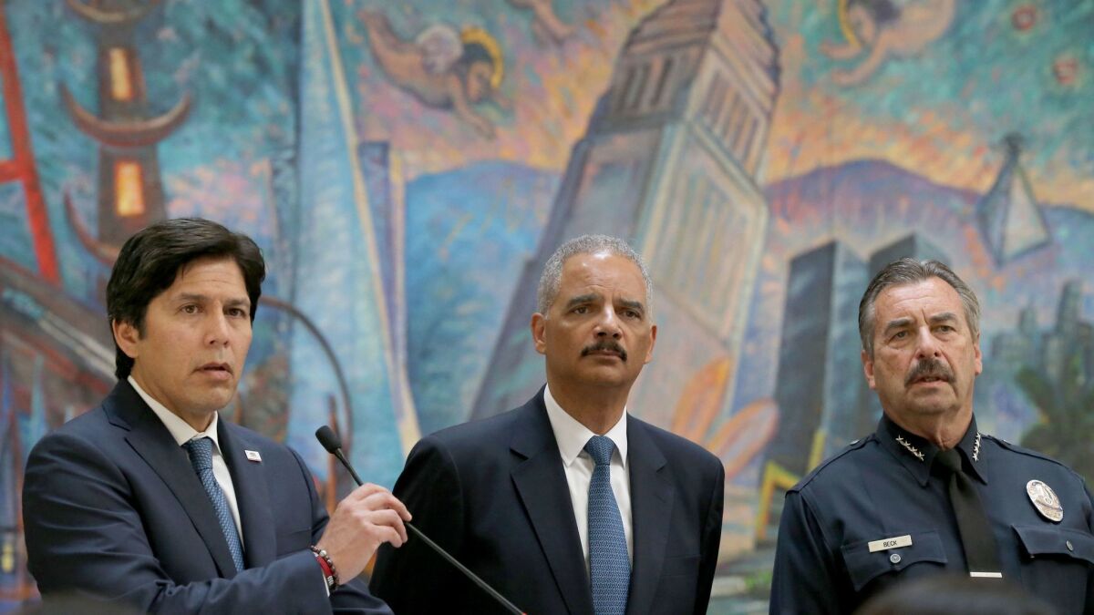 Former U.S. Atty. Gen. Eric H. Holder Jr., middle, and Los Angeles Police Chief Charlie Beck, right, listen to Senate leader Kevin de León discuss the so-called sanctuary state bill on June 19 in Los Angeles.