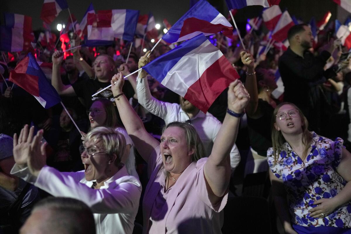 Supporters of French far right leader Marine Le Pen react after the release of vote count.