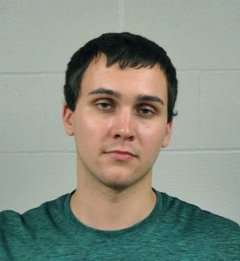 A young white man in a jail booking photo