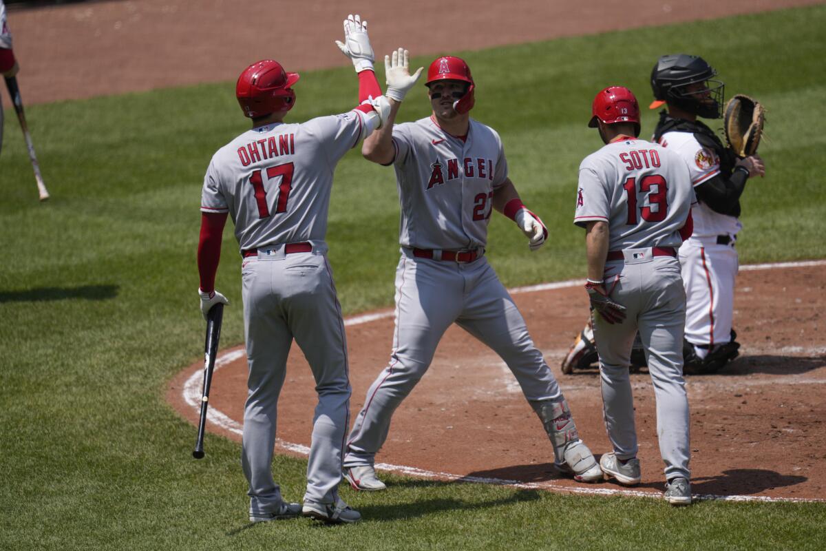 Los Angeles Angels' Gio Urshela (10) hits an RBI single during the