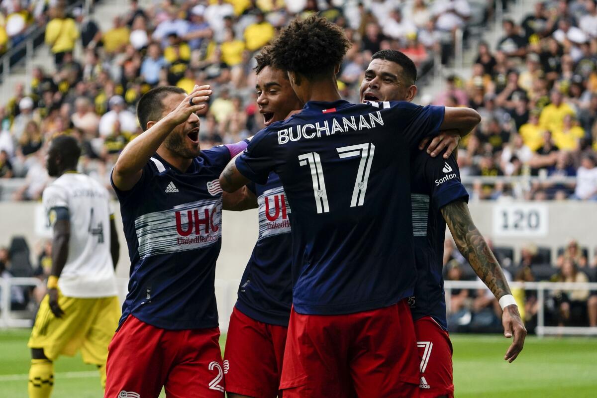 New England Revolution forward Gustavo Bou (7) celebrates with teammates after scoring a goal in the first half of an MLS soccer match against the Columbus Crew in Columbus, Ohio on Saturday, July 3, 2021. (AP Photo/Jeff Dean)