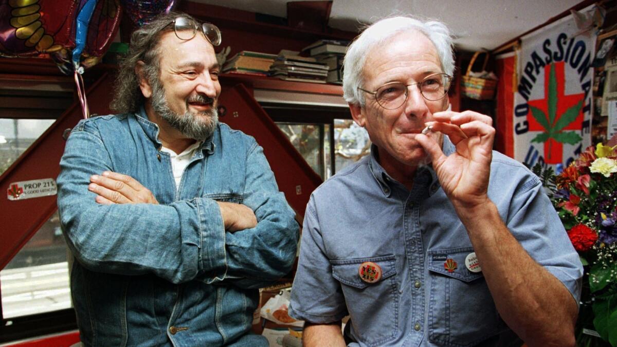 Dennis Peron, right, founder of the Cannabis Buyers Club and longtime activist, smokes marijuana in 1996 next to Jack Herer.