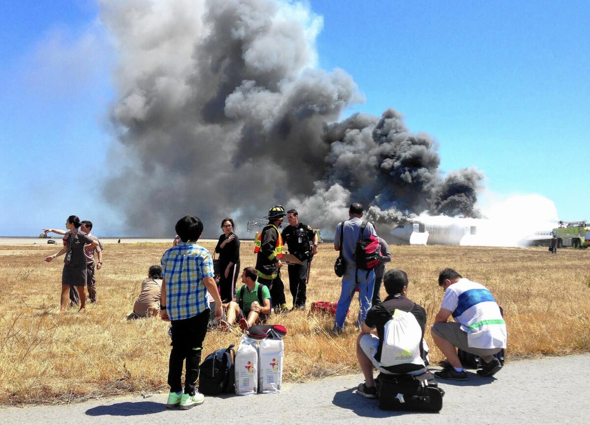 A photo taken by Benjamin Levy shows fellow passengers from Asiana Airlines Flight 214, many with their luggage, on the tarmac moments after the plane crashed at San Francisco International Airport on July 6, 2013.