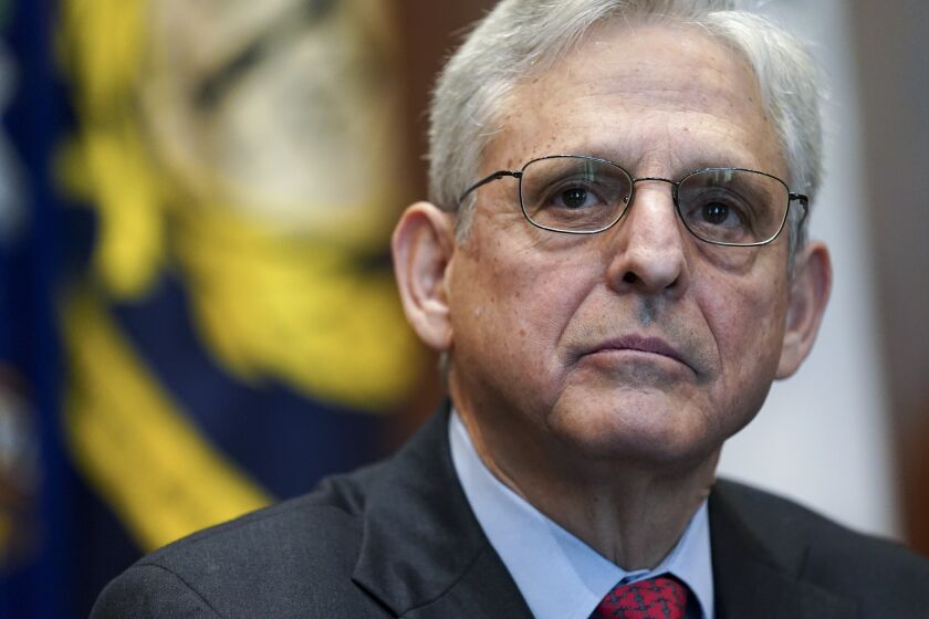 FILE - Attorney General Merrick Garland listens during a meeting of the COVID-19 Fraud Enforcement Task Force at the Justice Department, March 10, 2022 in Washington. The lawmakers investigating the Jan. 6 attack on the Capitol have been increasingly using their public statements, court filings and committee reports to deliver a blunt message to Garland and the Department of Justice to act on their findings. (Kevin Lamarque/Pool Photo via AP, File)