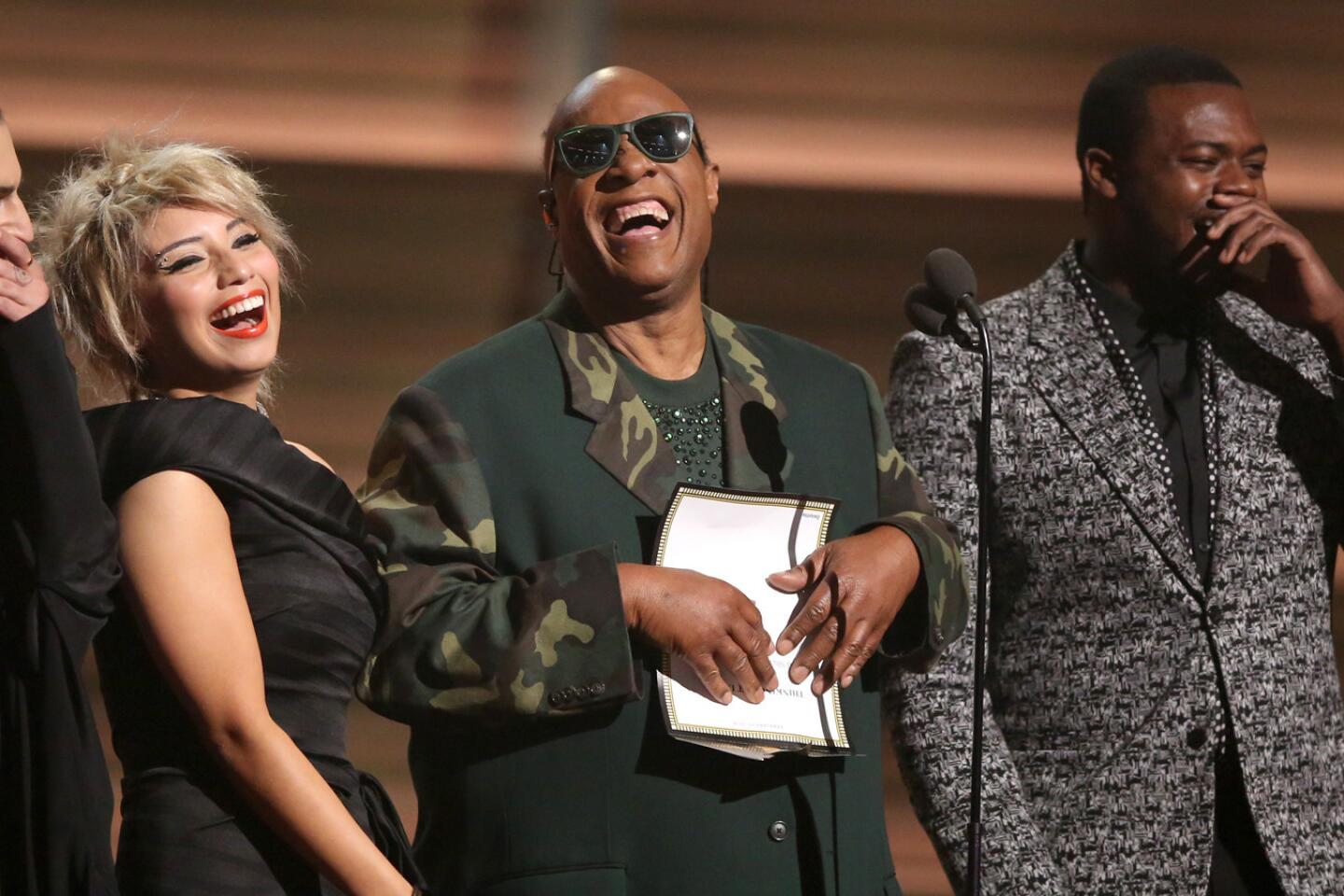 Stevie Wonder, center, and Mitch Grassing, left, Kristin Maldonado and Kevin Olusola of Pentatonix present the award for song of the year.