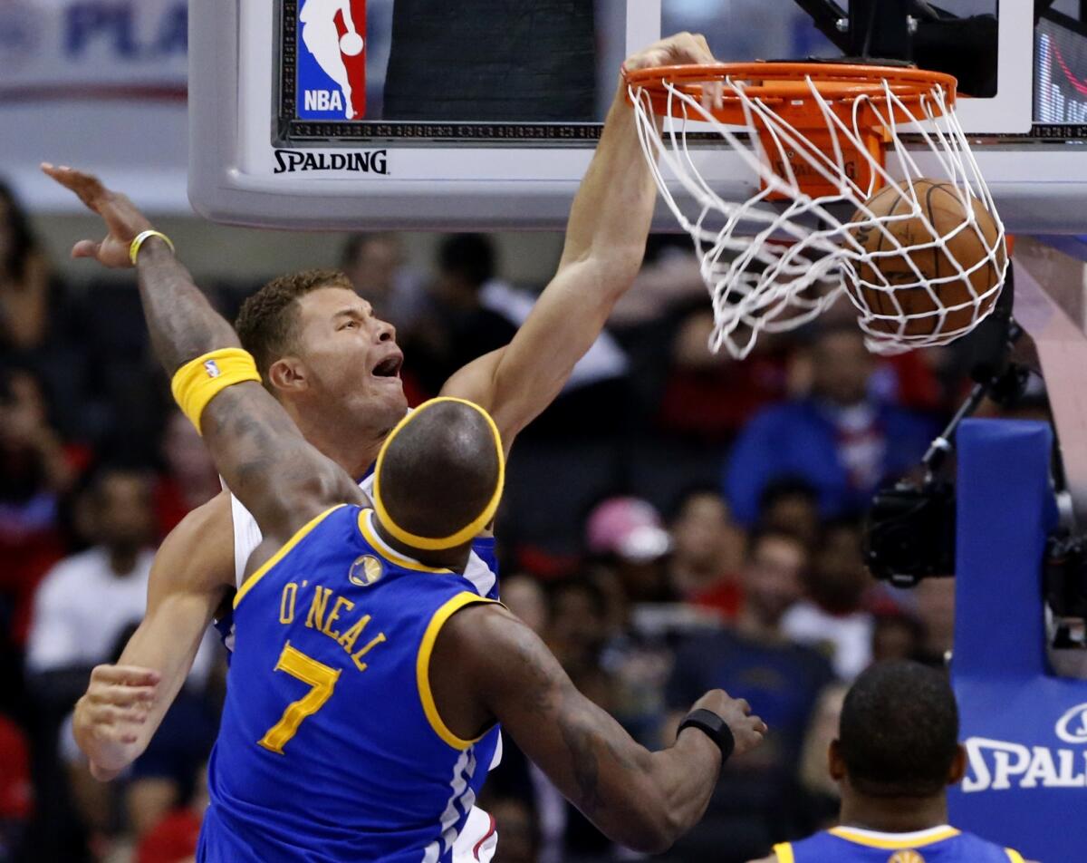 Clippers power forward Blake Griffin slams the ball past Warriors center Jermaine O'Neal in the second half Saturday afternoon during Game 1 at Staples Center.