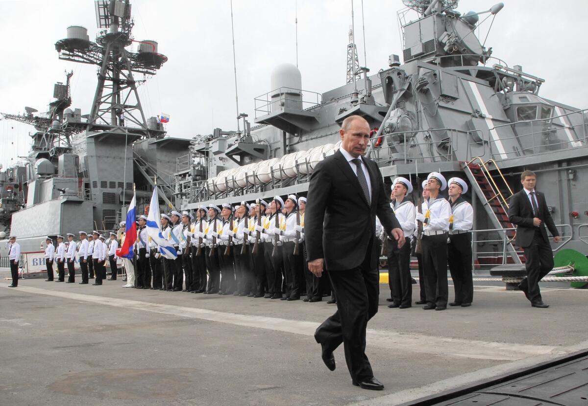 Russian President Vladimir Putin visits the destroyer Vice-Admiral Kulakov at the Black Sea fleet naval base in Novorossiysk, Russia, on Sept. 23, 2014.