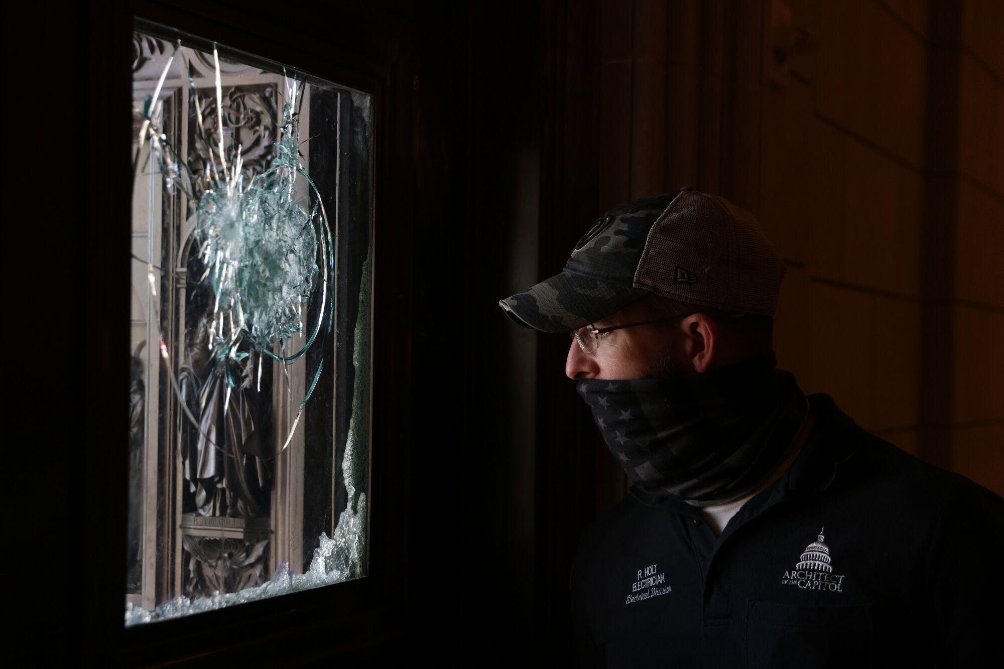 A member of the Architect of the Capitol inspects a damaged entrance of the U.S. Capitol Tursday in Washington, DC.