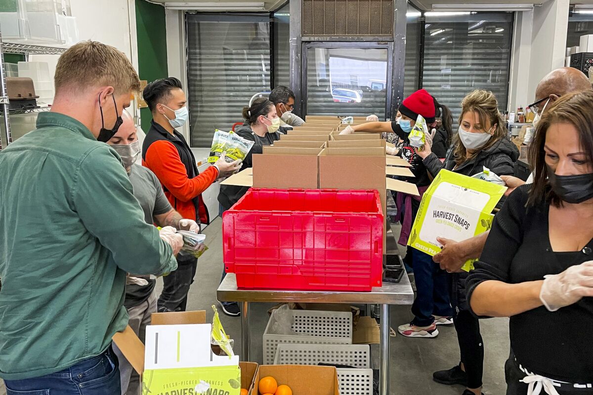 Volunteers with the Hollywood Food Coalition prepare boxes.