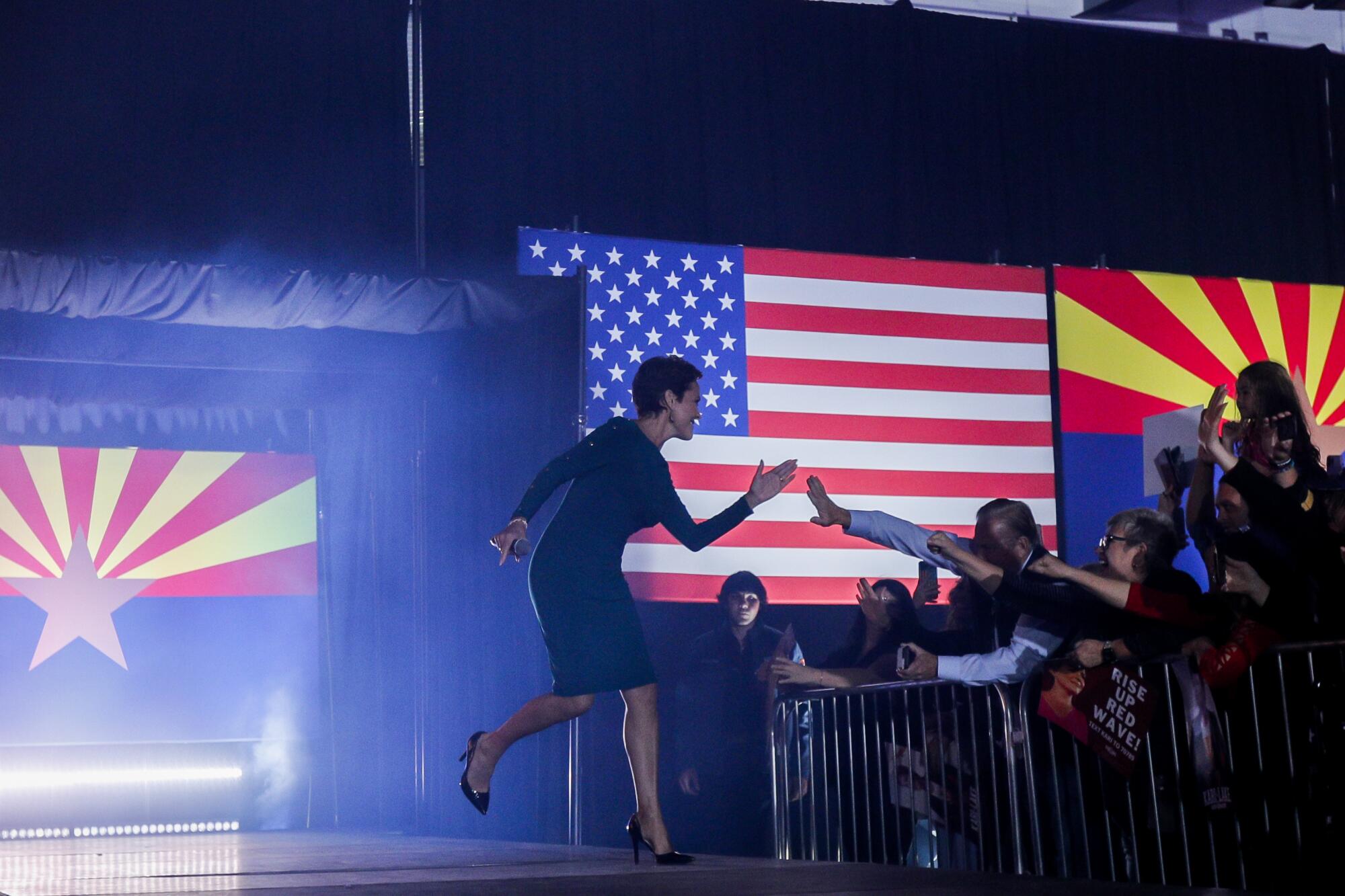 Arizona GOP gubernatorial candidate Karie Lake greets supporters as she takes the stage for a campaign rally