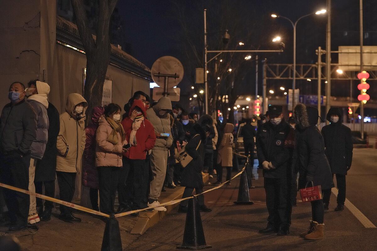 People line up in cold weather for coronavirus testing in Beijing