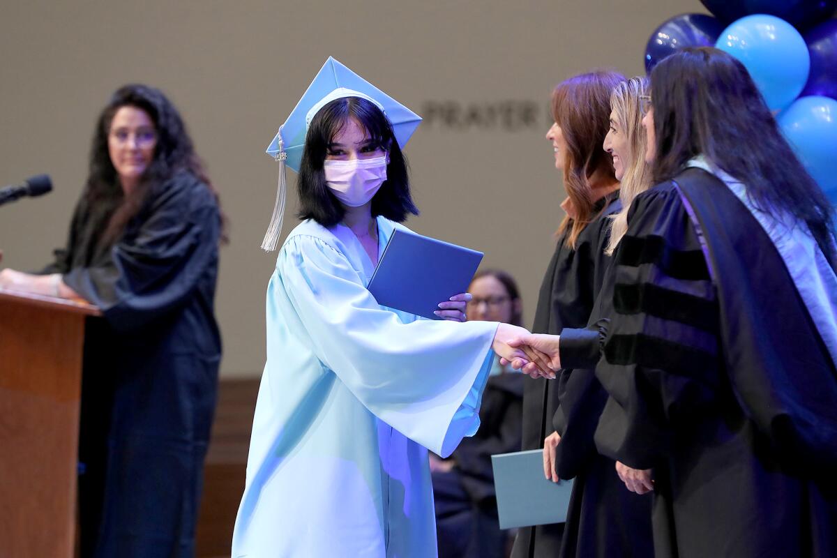 Carina Garcia proudly walks with her diploma.