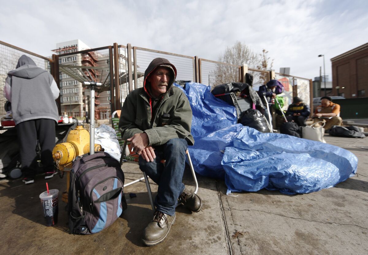 Salvatore Garofalo sits in a lawn chair in a makeshift homeless camp across from the Denver Rescue Mission in downtown Denver.
