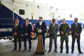 Vice President JD Vance, center, speaks next to officials at the Wilshire Federal Building