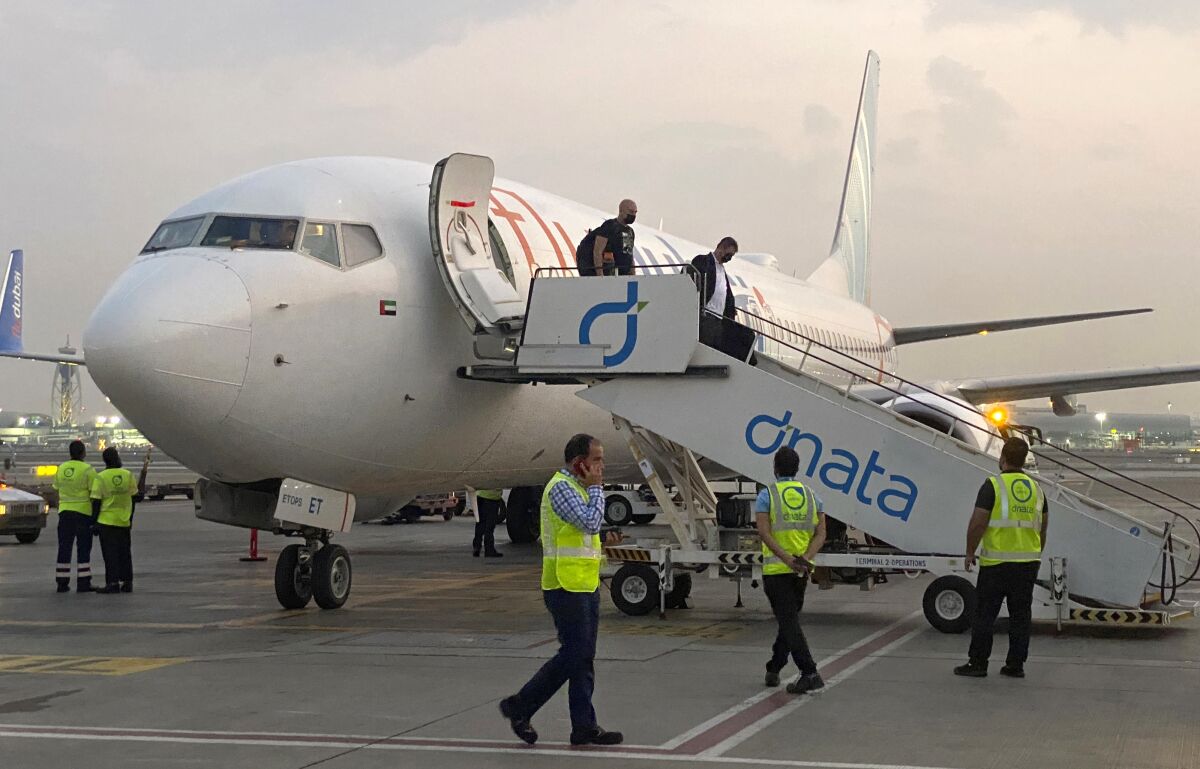 FILE - Israeli tourists leave a flydubai plane which departed from Ben-Gurion International Airport in Tel Aviv and landed in Dubai, United Arab Emirates, Nov. 8, 2020. FlyDubai on Monday, March 7, 2022, reported a $229 million profit last year as the state-owned budget carrier saw its business rebound from the coronavirus pandemic and as regulators allowed it to again fly the Boeing 737 Max. The carrier said Tel Aviv was one of its top routes across its network in 2021. (AP Photo/Malak Harb, File)