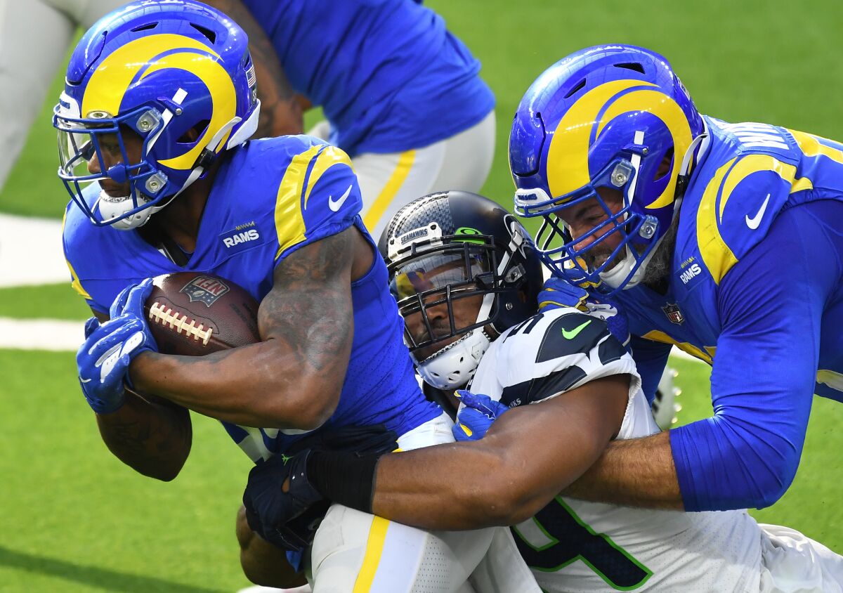 Rams running back Cam Akers is tackled by Seahawks linebacker Bobby Wagner.