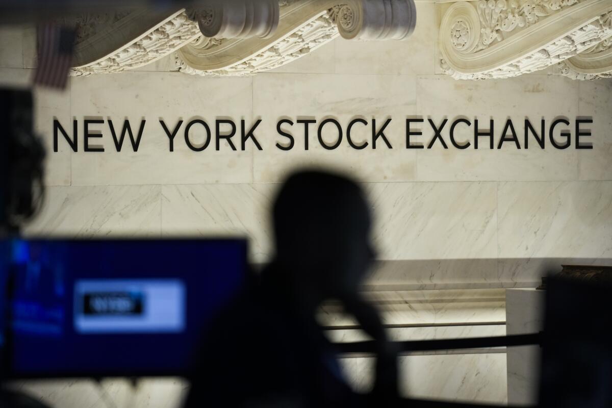 Traders work on the floor at the New York Stock Exchange in New York.