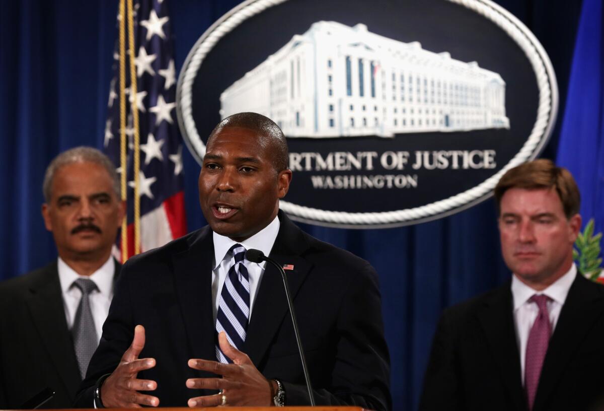 Associate Atty. Gen. Tony West discusses a financial fraud case on Aug. 21 as Atty. Gen. Eric H. Holder Jr., left, and Kentucky Atty. Gen. Jack Conway look on. On Wednesday, West announced his resignation.