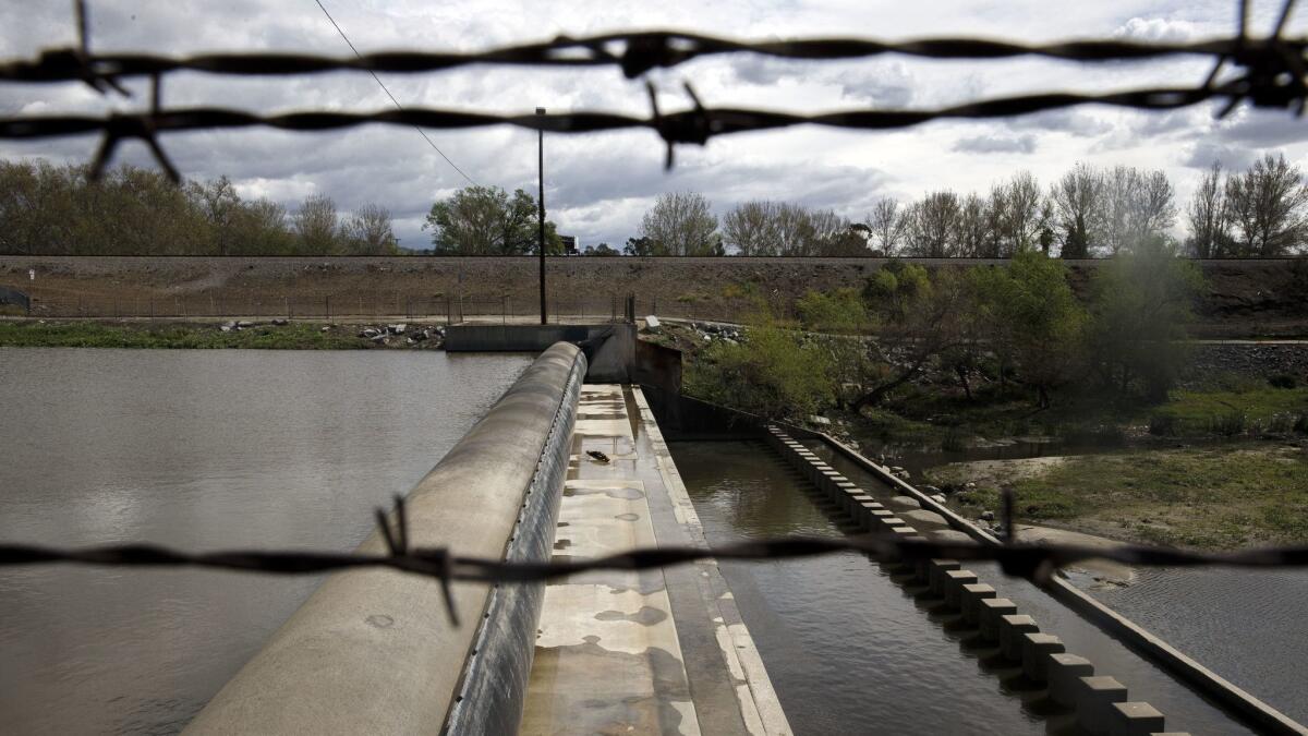 An inflatable dam diverts water from the San Gabriel River to the Paseo del Rio at San Gabriel Coast Basin spreading grounds in Pico Rivera, Calif. on March 7, 2016.