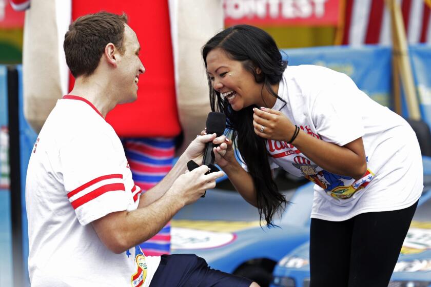 Champion eater Joey Chestnut proposes at Nathan's hot dog eating contest on Coney Island, N.Y., on Friday.
