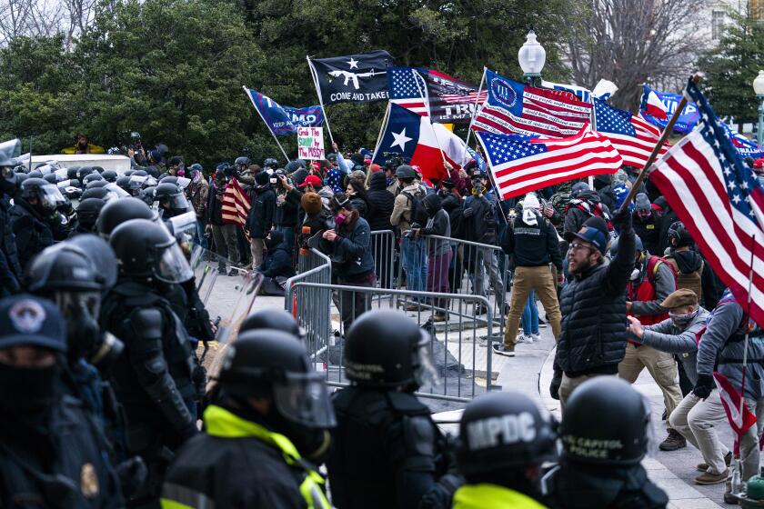 FILE - Supporters of President Donald Trump are confronted by U.S. Capitol Police officers outside the Capitol, Wednesday, Jan. 6, 2021, in Washington. The FBI arrested three Florida residents on Saturday, Jan. 6, 2024, the third anniversary of their alleged attack on Capitol police officers during the Jan. 6, 2021, insurrection. (AP Photo/Manuel Balce Ceneta, File)