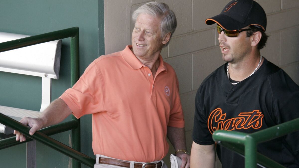San Francisco Giants Managing General Partner Peter Magowan, left, visiting with center fielder Aaron Rowand before a spring training game against the Oakland Athletics in 2008.